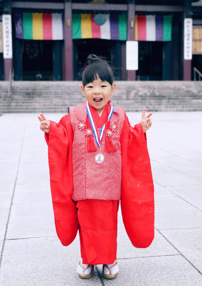 神奈川県川崎大師の境内でポーズをとる七五三の女の子