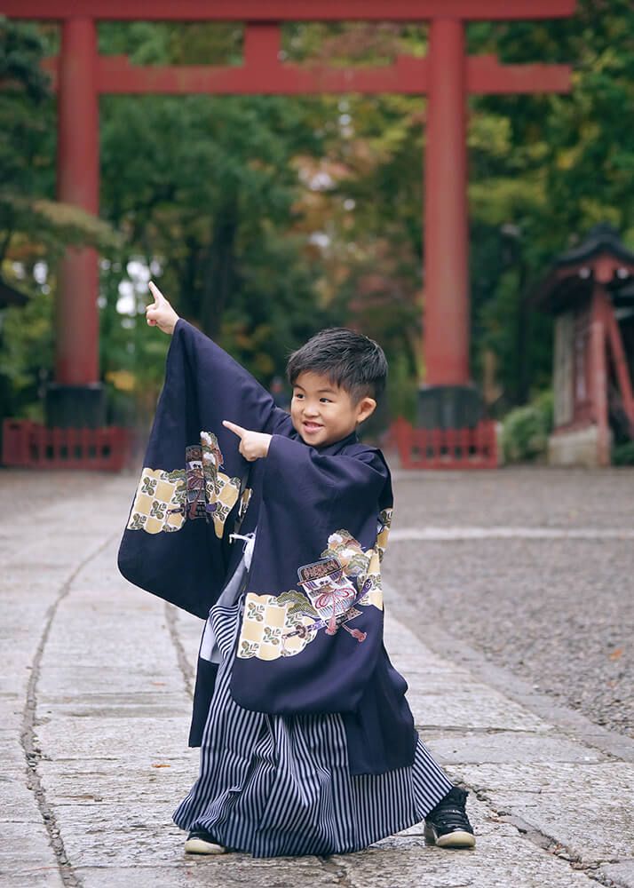 大宮氷川神社の参道でポーズをとる七五三の男の子