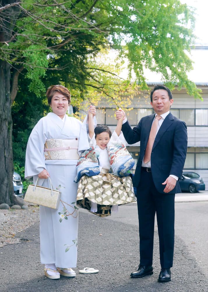 赤坂日枝神社での七五三出張撮影でパパとママと手を繋いでジャンプする男の子の写真